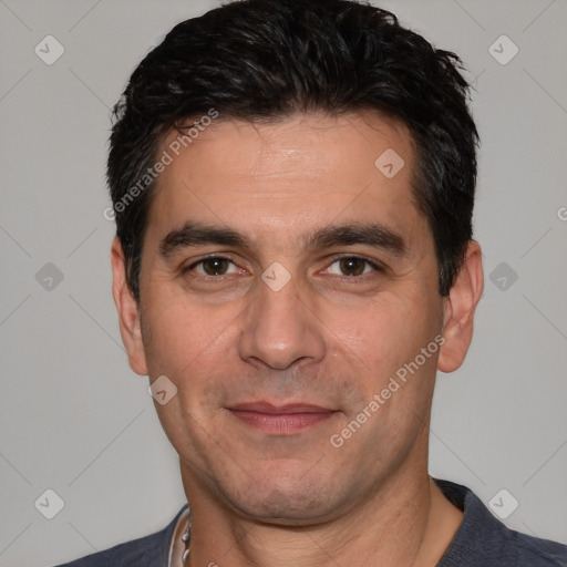 Joyful white adult male with short  black hair and brown eyes