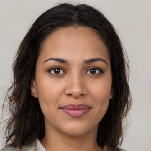 Joyful latino young-adult female with medium  brown hair and brown eyes