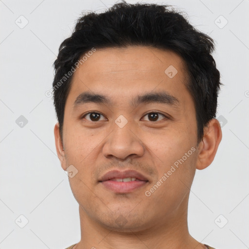 Joyful asian young-adult male with short  black hair and brown eyes