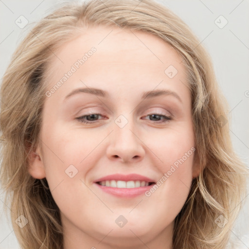 Joyful white young-adult female with long  brown hair and blue eyes