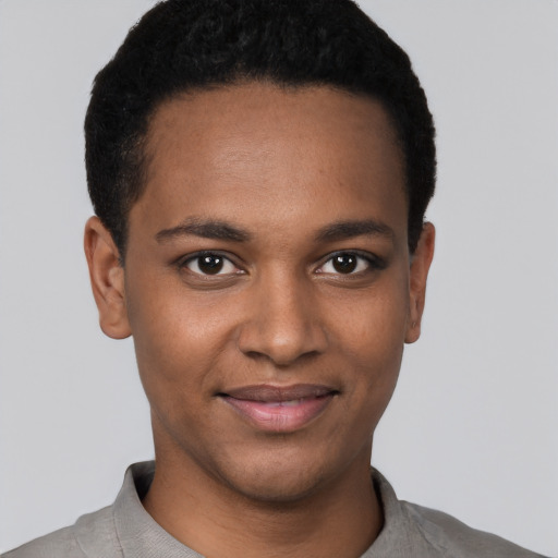 Joyful black young-adult male with short  black hair and brown eyes