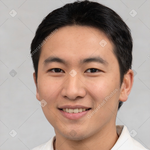 Joyful asian young-adult male with short  black hair and brown eyes