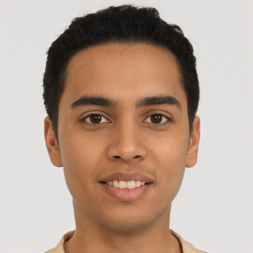 Joyful latino young-adult male with short  black hair and brown eyes