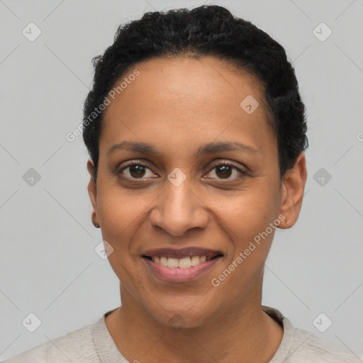 Joyful latino young-adult female with short  black hair and brown eyes