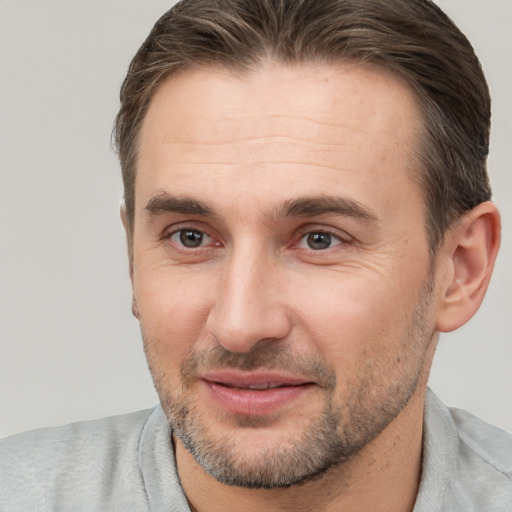 Joyful white adult male with short  brown hair and brown eyes