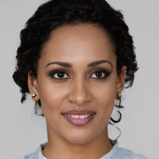 Joyful black young-adult female with short  brown hair and brown eyes