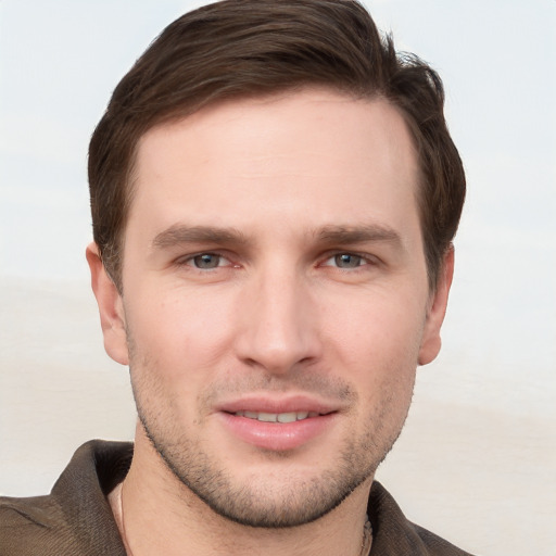 Joyful white young-adult male with short  brown hair and grey eyes