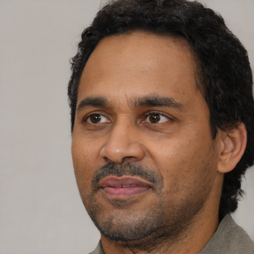 Neutral black adult male with short  black hair and brown eyes