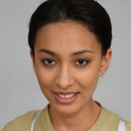 Joyful latino young-adult female with short  brown hair and brown eyes