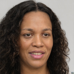 Joyful white adult female with long  brown hair and brown eyes