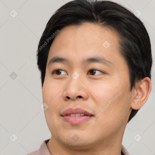 Joyful asian young-adult male with short  brown hair and brown eyes