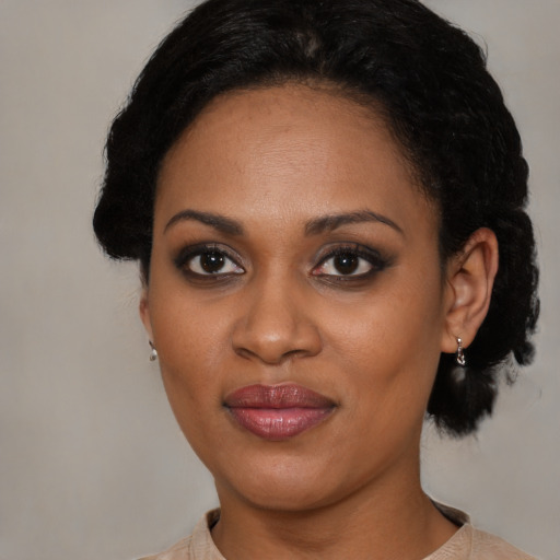 Joyful black young-adult female with medium  black hair and brown eyes