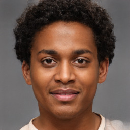 Joyful black young-adult male with short  brown hair and brown eyes