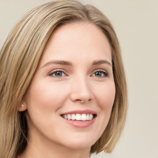 Joyful white young-adult female with long  brown hair and green eyes