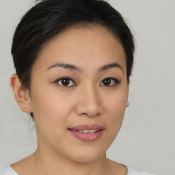 Joyful asian young-adult female with short  brown hair and brown eyes