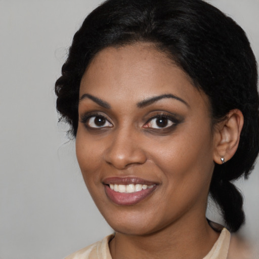 Joyful latino young-adult female with medium  black hair and brown eyes