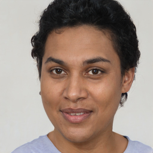 Joyful latino adult female with short  brown hair and brown eyes