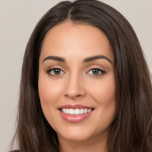 Joyful white young-adult female with long  brown hair and brown eyes