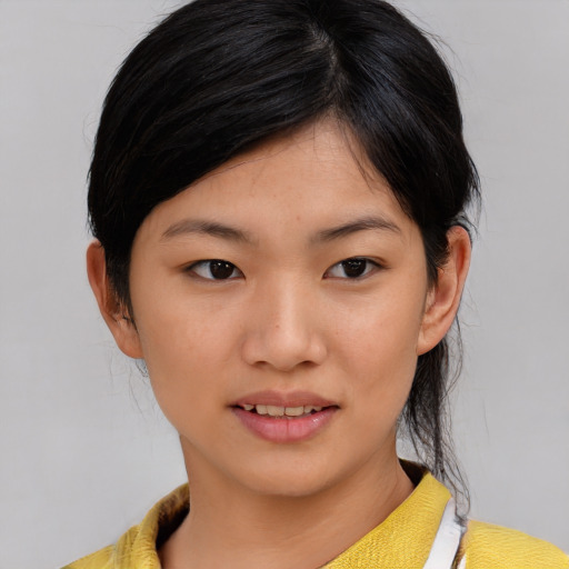 Joyful asian young-adult female with medium  brown hair and brown eyes