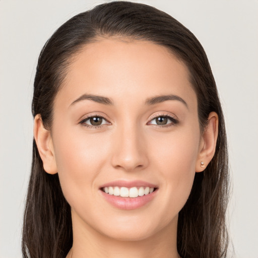 Joyful white young-adult female with long  brown hair and brown eyes