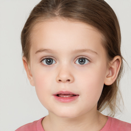 Joyful white child female with medium  brown hair and brown eyes