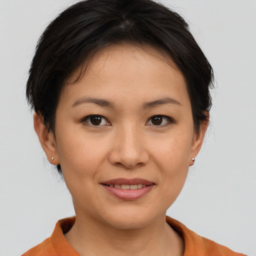 Joyful asian young-adult female with short  brown hair and brown eyes