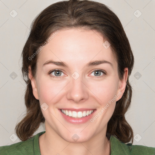 Joyful white young-adult female with medium  brown hair and green eyes