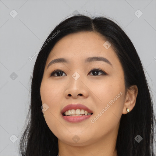 Joyful asian young-adult female with long  black hair and brown eyes