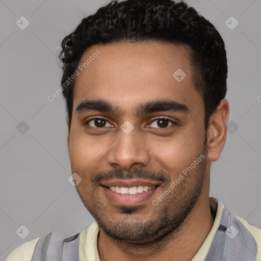 Joyful latino young-adult male with short  black hair and brown eyes