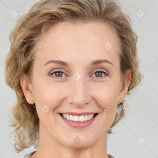 Joyful white young-adult female with medium  brown hair and blue eyes