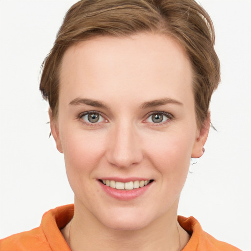 Joyful white young-adult female with short  brown hair and blue eyes