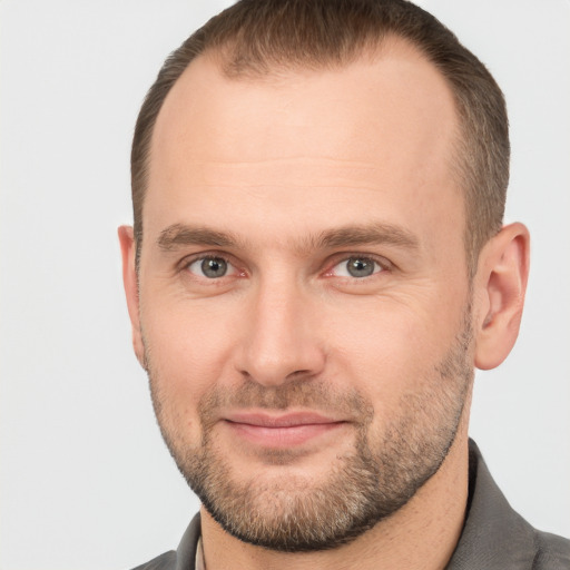 Joyful white adult male with short  brown hair and grey eyes