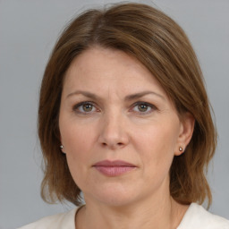 Joyful white adult female with medium  brown hair and grey eyes