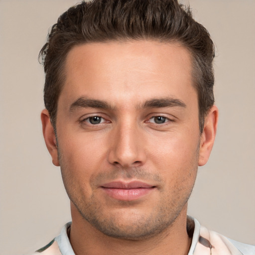 Joyful white young-adult male with short  brown hair and brown eyes