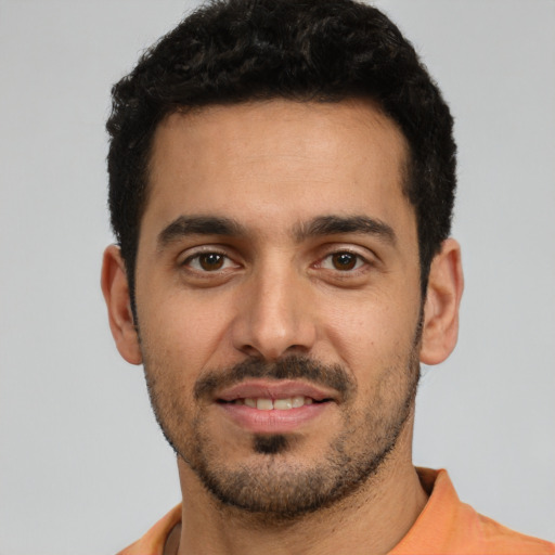 Joyful white young-adult male with short  black hair and brown eyes