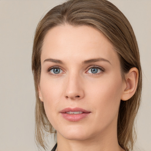 Joyful white young-adult female with medium  brown hair and grey eyes