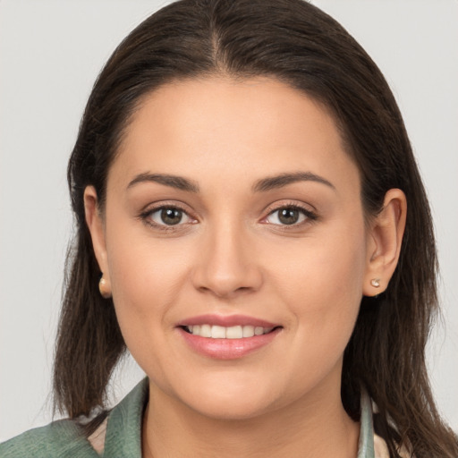 Joyful white young-adult female with medium  brown hair and brown eyes