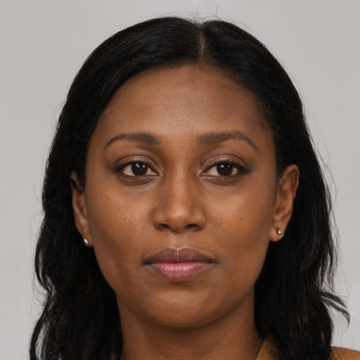 Neutral black young-adult female with long  brown hair and brown eyes