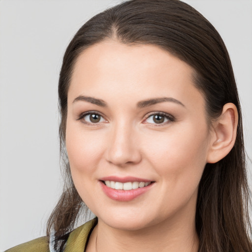 Joyful white young-adult female with long  brown hair and brown eyes