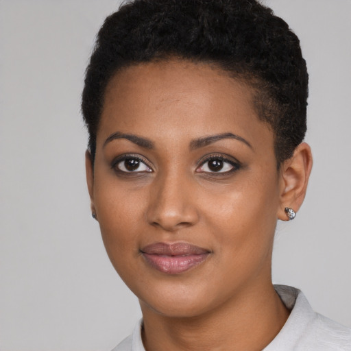 Joyful black young-adult female with short  black hair and brown eyes