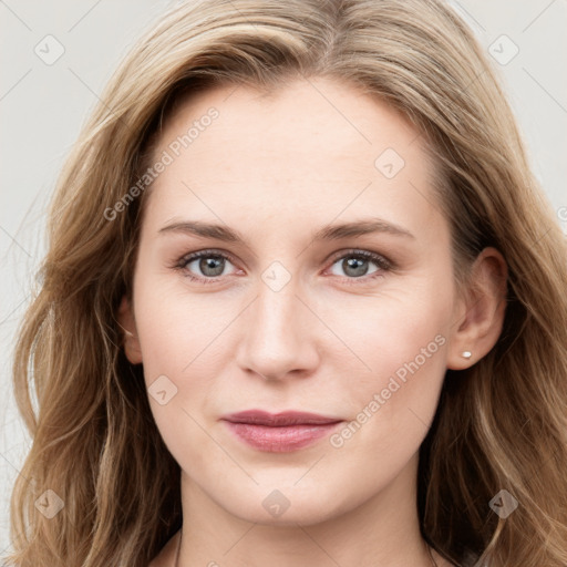 Joyful white young-adult female with long  brown hair and blue eyes