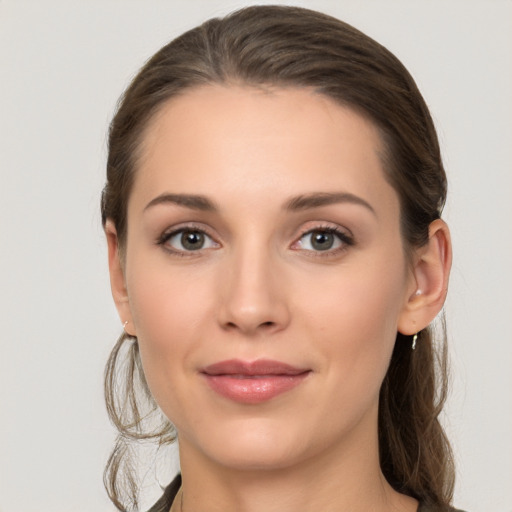 Joyful white young-adult female with long  brown hair and grey eyes