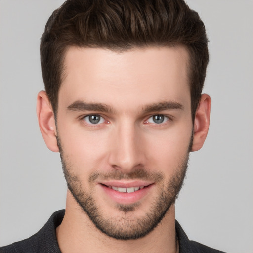 Joyful white young-adult male with short  brown hair and grey eyes