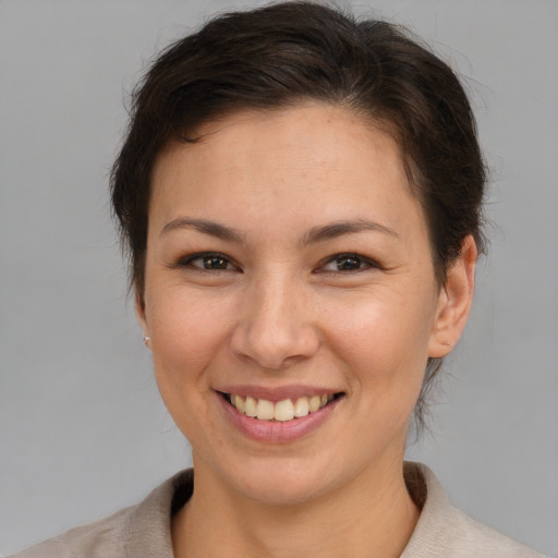 Joyful white young-adult female with medium  brown hair and brown eyes