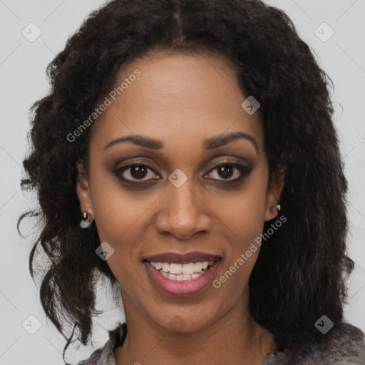 Joyful black young-adult female with long  brown hair and brown eyes