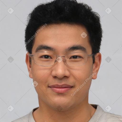 Joyful asian young-adult male with short  black hair and brown eyes