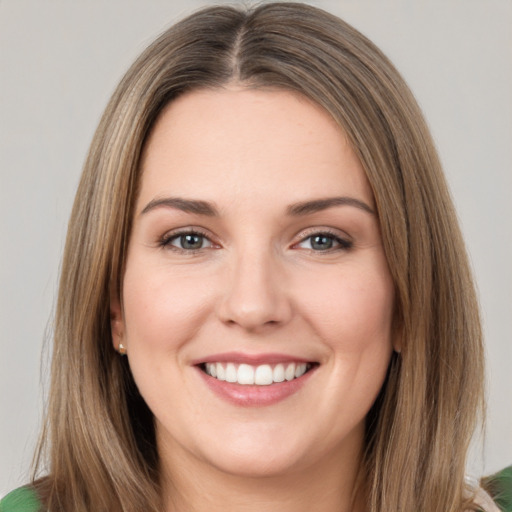 Joyful white young-adult female with medium  brown hair and green eyes