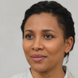 Joyful black adult female with short  brown hair and brown eyes