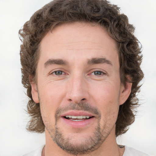 Joyful white adult male with short  brown hair and grey eyes