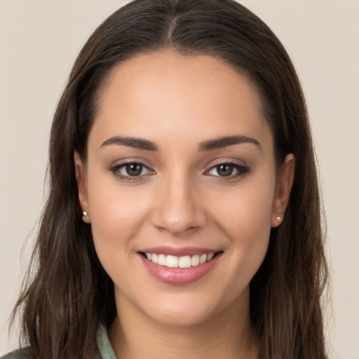 Joyful white young-adult female with long  brown hair and brown eyes